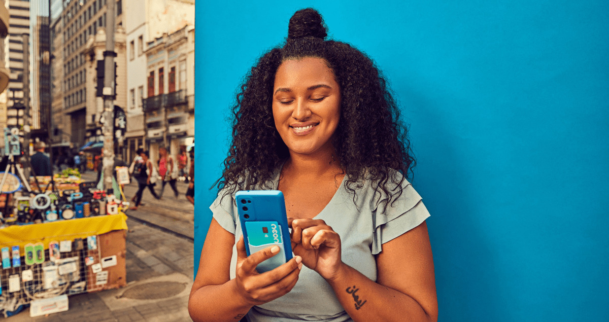 Mulher segurando celular sorrindo