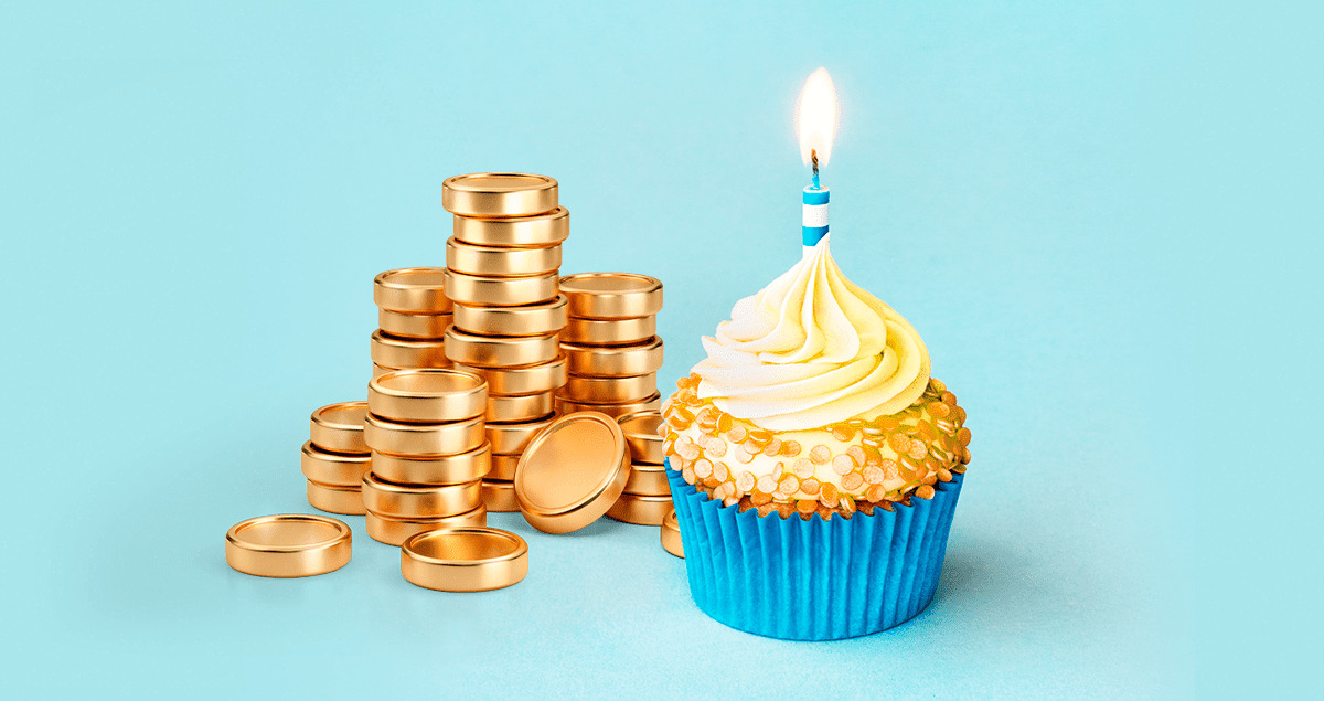 Moedas ao lado de cupcake com vela em cima