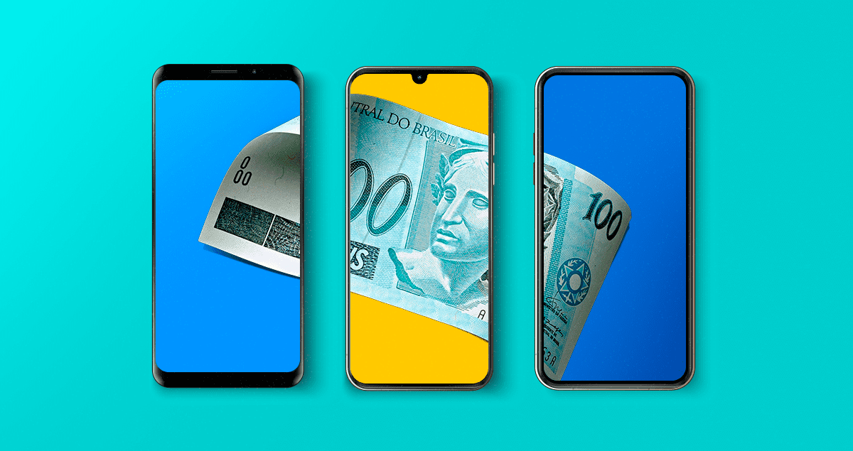 Cédula de cem reais sobre três celulares