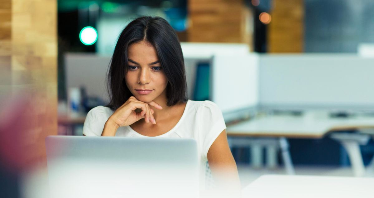 Mulher séria em frente a computador
